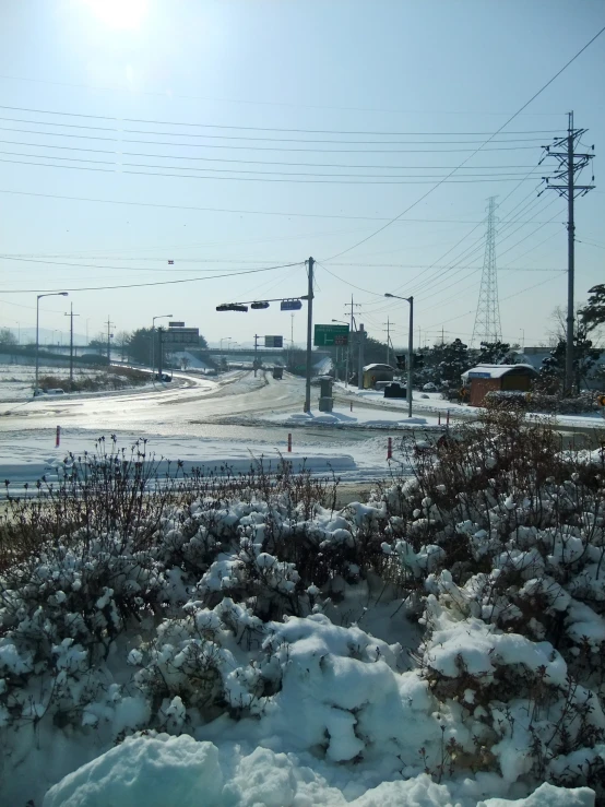 a snowy field with snow on it and power poles in the background