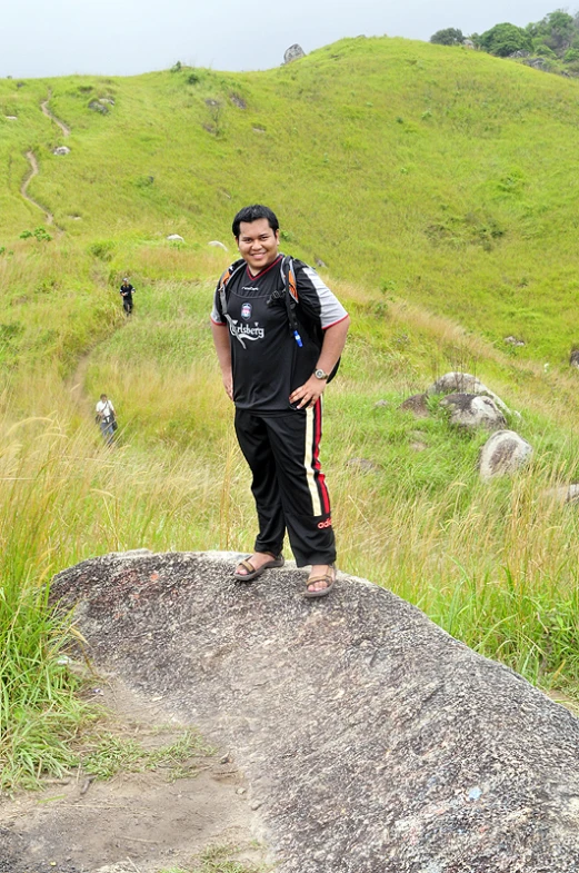 a man in the mountains wearing some sandals