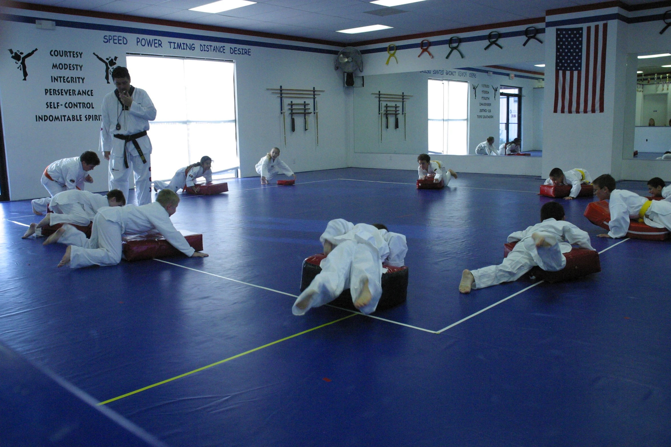 a group of people doing karate in a room