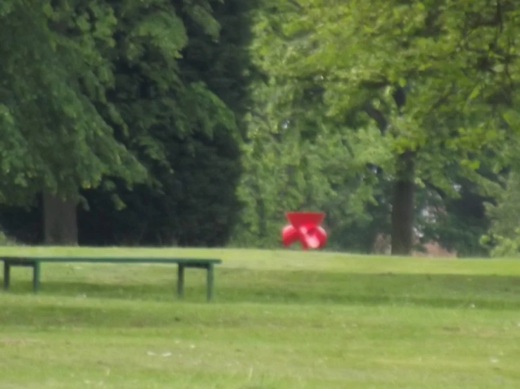 a couple of benches sitting in a field