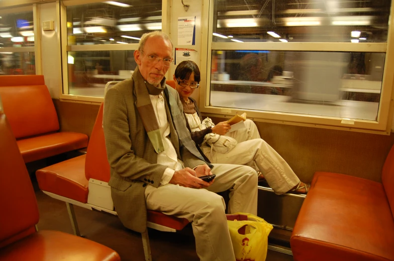 a couple is sitting on a train car