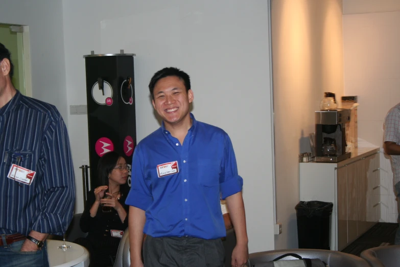 man standing in middle of room smiling for camera