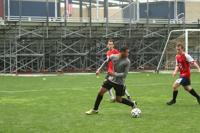 several young men play soccer on the grass