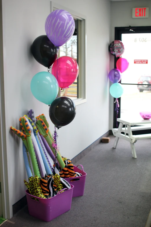 a set of plastic buckets with large balloons stuck on them