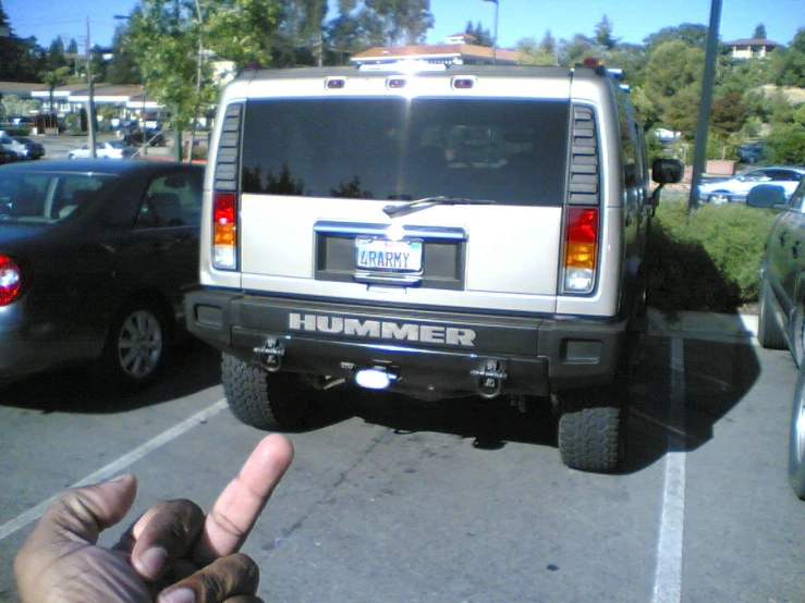 a hummer van that is pointing to the side in a parking lot