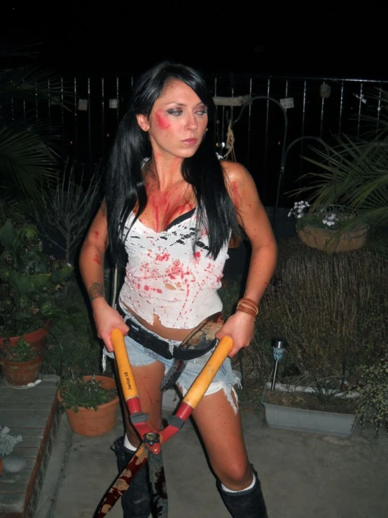 a woman dressed as zombie riding on top of a skateboard