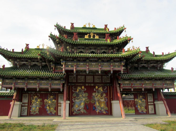 a building with many roof tiles, some men and women on the roof