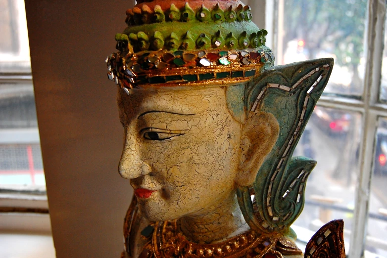 a statue of a woman with a erfly sitting on her head