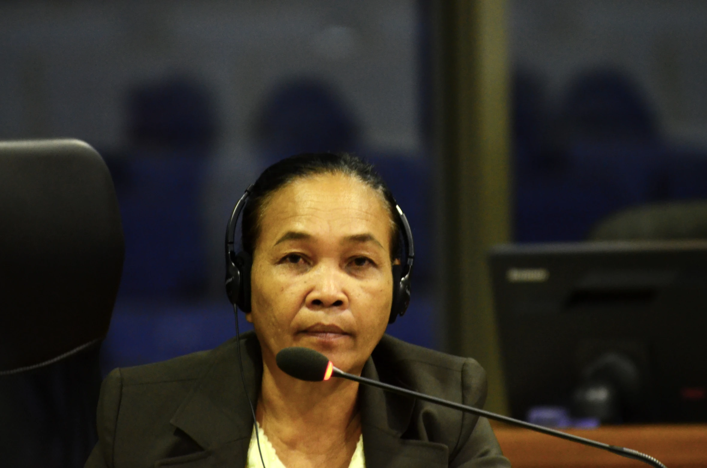 woman sitting at desk in front of computer talking on a phone