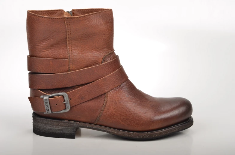 a pair of brown boots with straps are shown