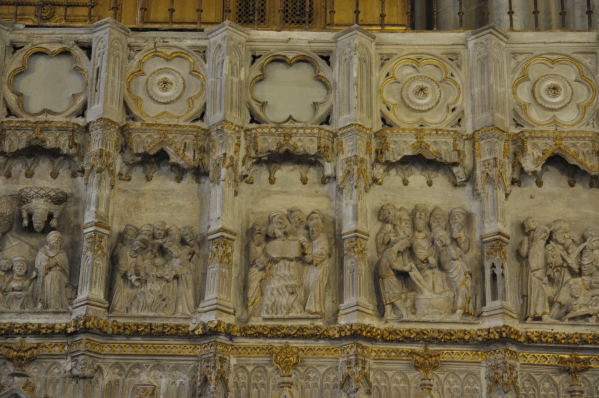 carvings of people, animals and plants on the side of a building