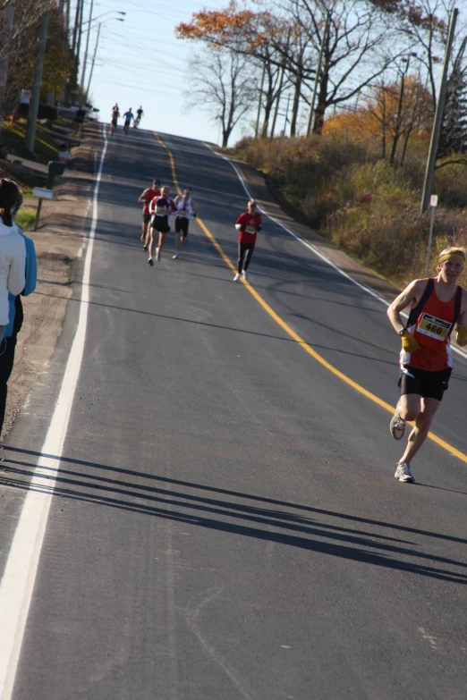 a group of men running down a road