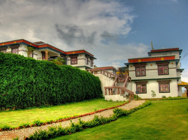 a house with red trim next to a green lawn