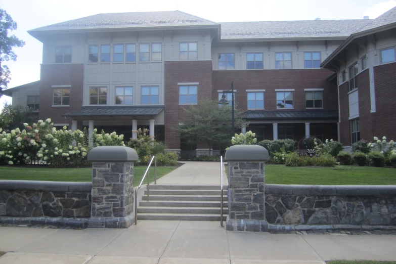 a building with a stone wall, and steps leading to the entrance