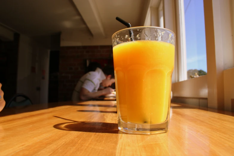 a drink in a glass is sitting on the table