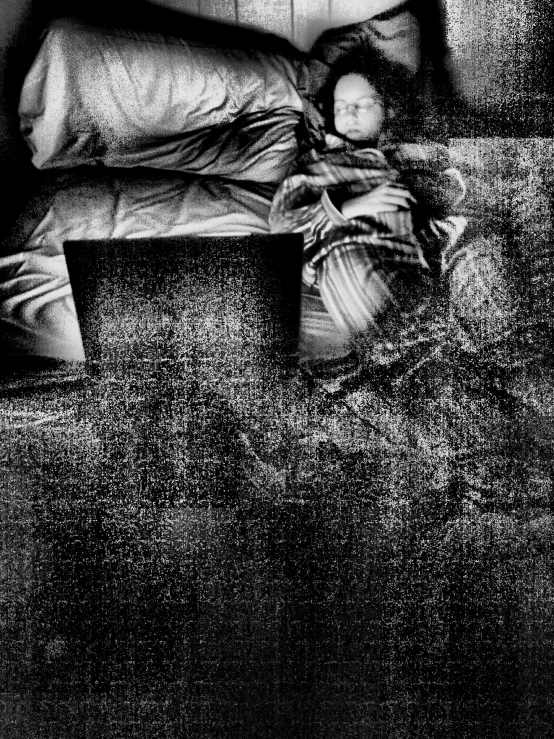 a man sleeping on a couch in a dark room
