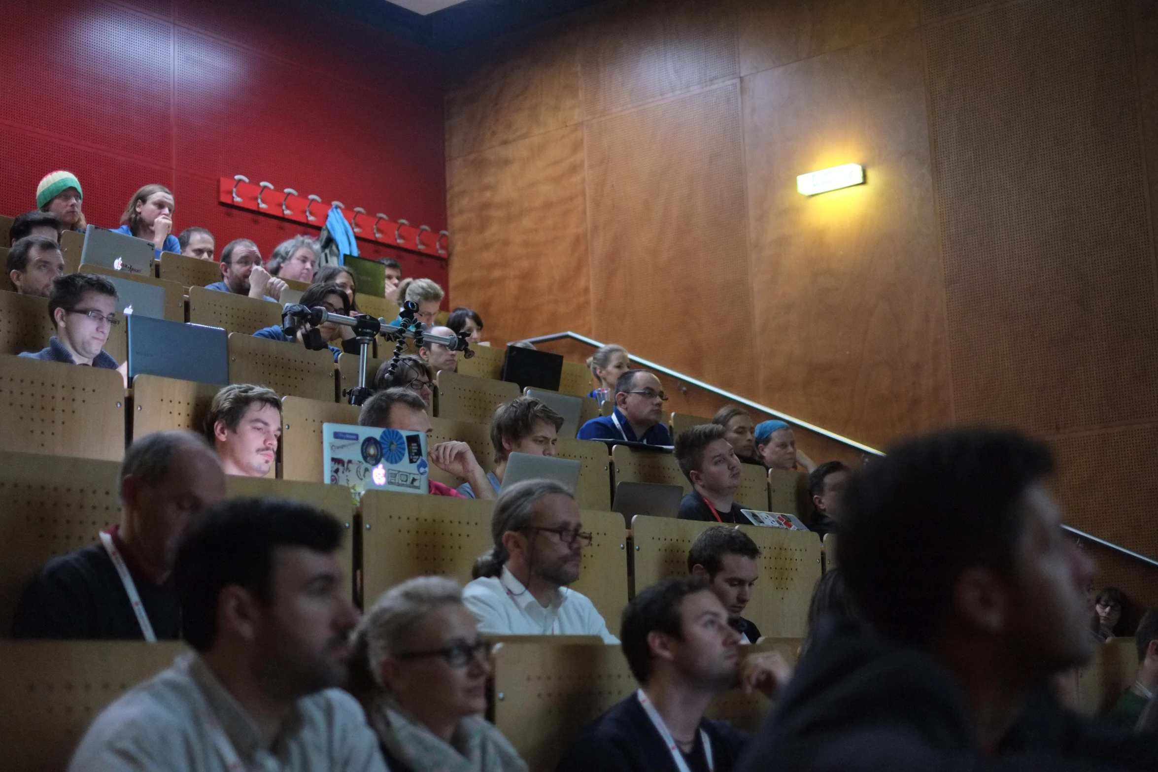 a large group of people are looking up and sitting in an auditorium