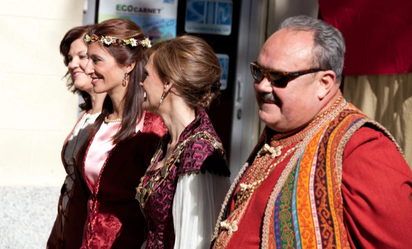 a man and woman wearing matching red clothes next to each other