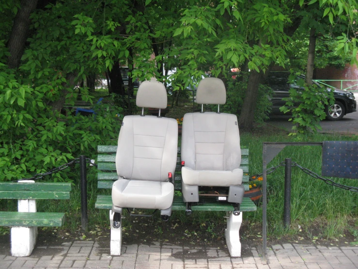 two seats on a park bench with other park benches behind