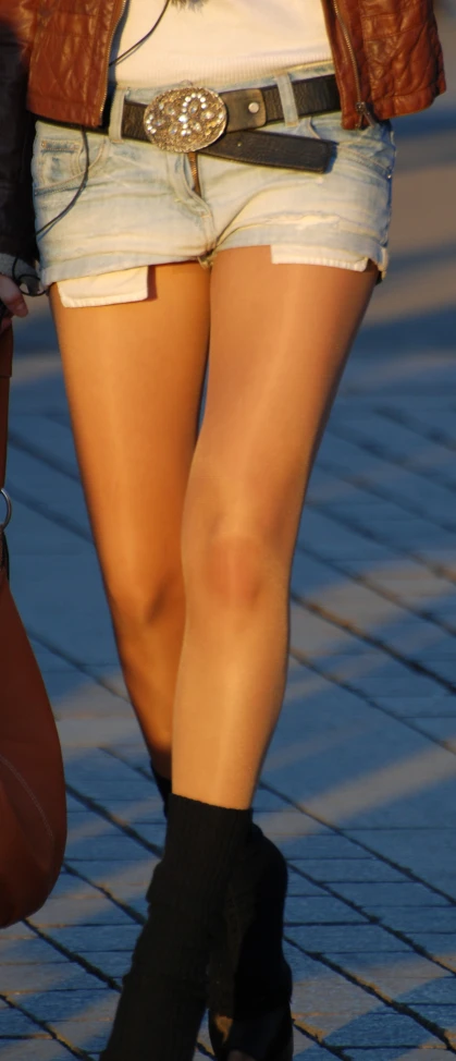 a person's legs with a belt around their waist