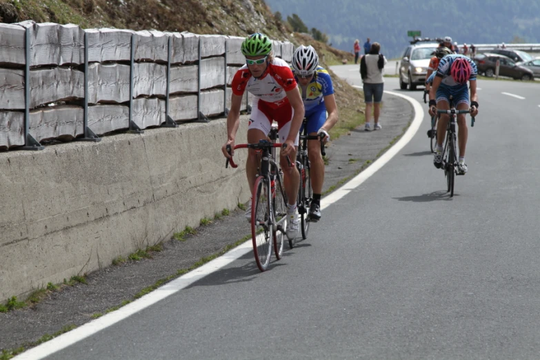 a group of people riding bicycles down a road