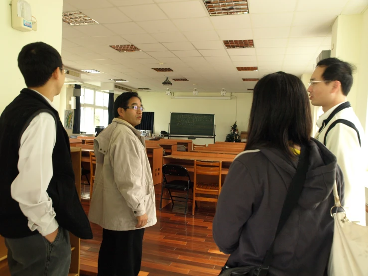 four people in a room talking to each other