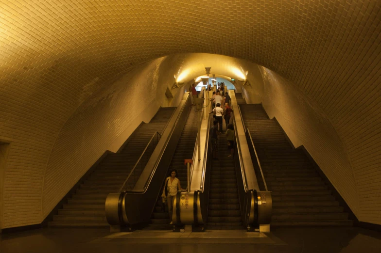 a long escalator has people walking down it