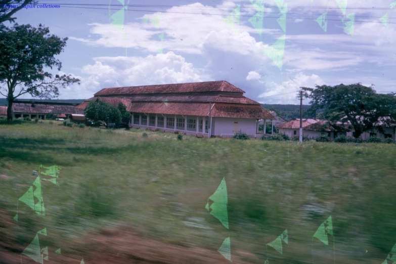 an exterior view of a house with trees around it