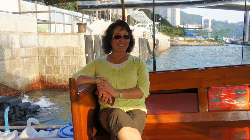 a woman sitting at a wooden boat dock