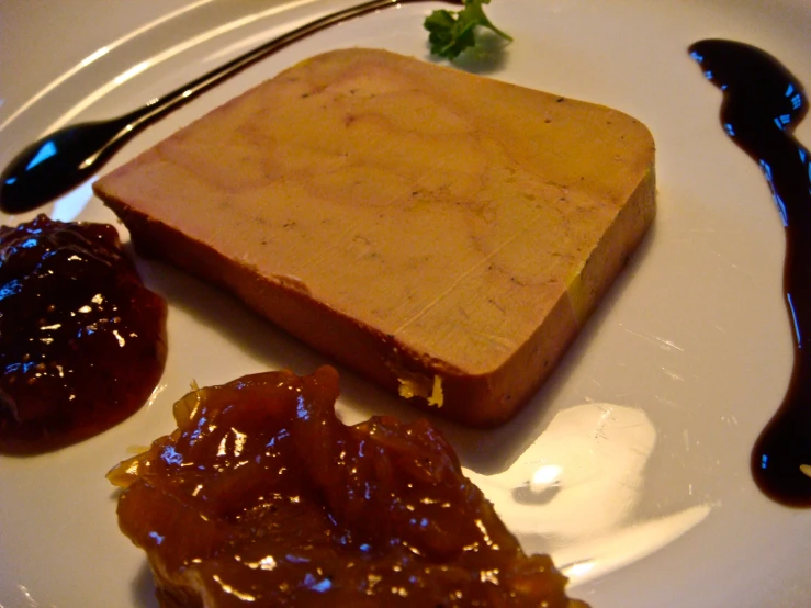 there is some fruit on this plate that has a square sandwich on it