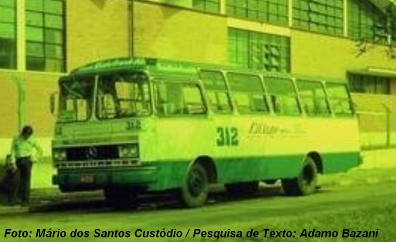 a green and white bus next to a building