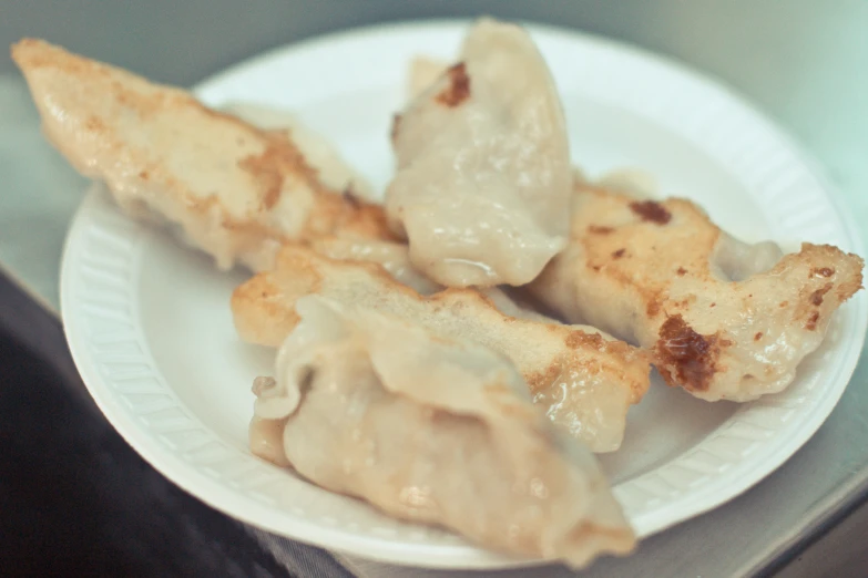 a plate with dumplings on it is next to a counter