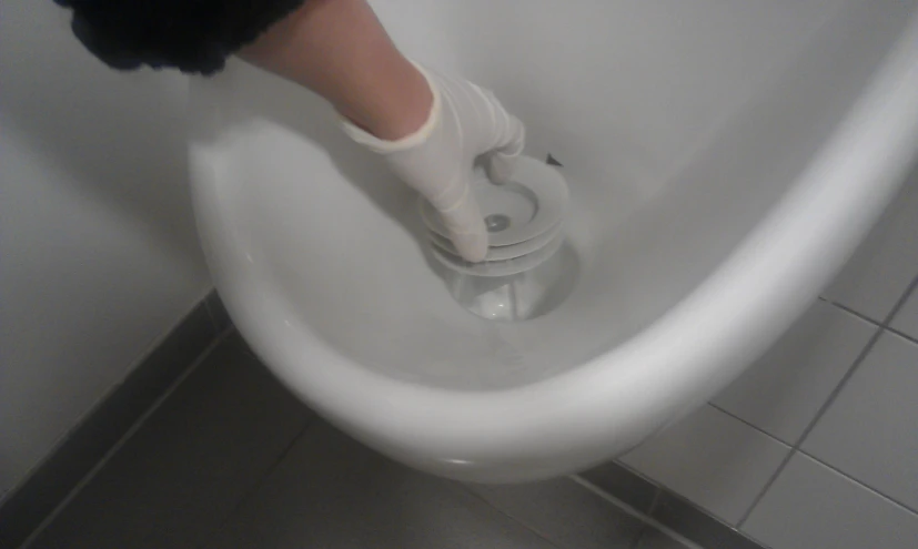 a persons leg stepping onto the side of a toilet bowl