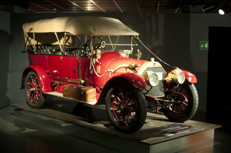 an old fashioned car on display at a museum