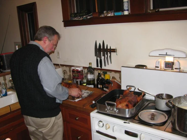 a man stands in the kitchen preparing food