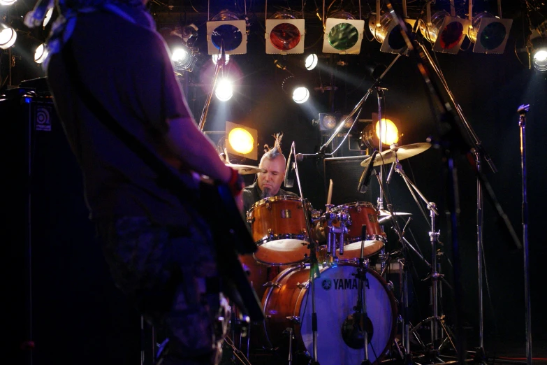 a man playing the drums while on stage