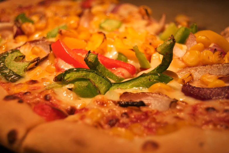 a pizza topped with peppers, green onions and corn