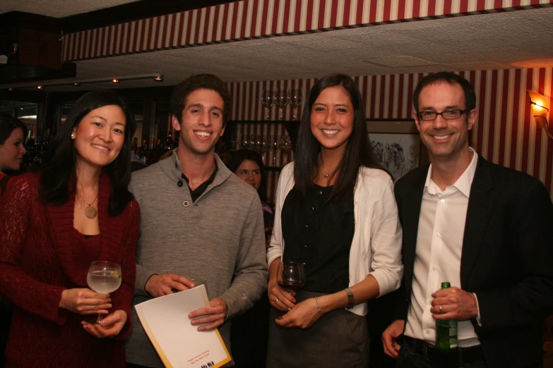 three men and two women smiling for a po