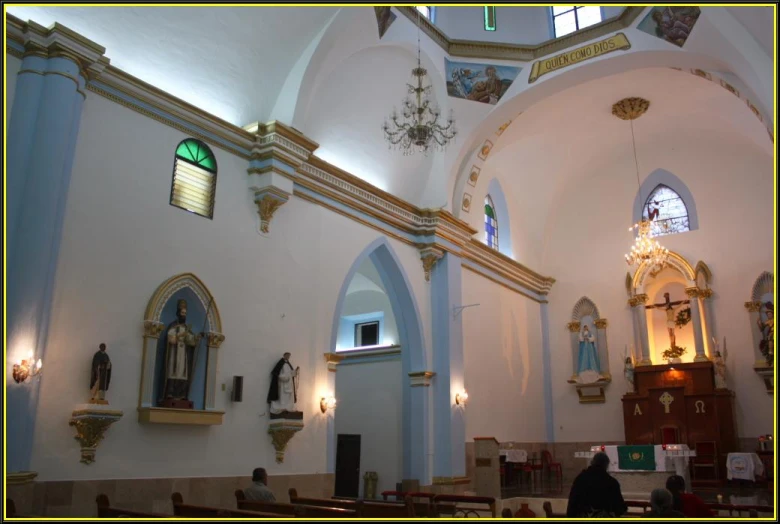 a church with a high vaulted ceiling and gold trim