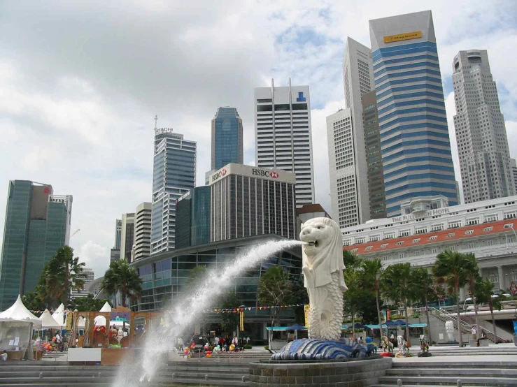 a water fountain and white bear statue in a city