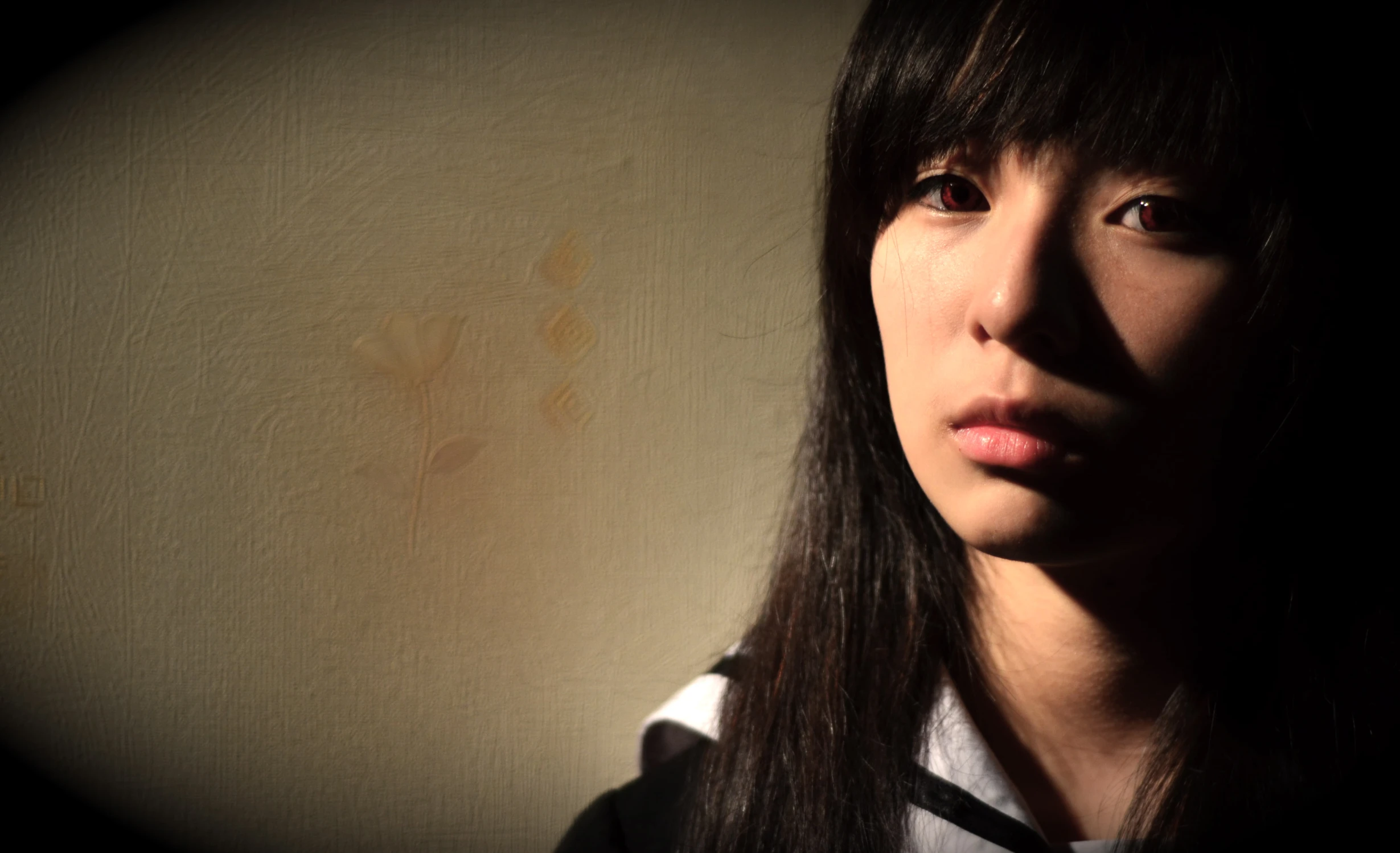 an asian girl posing in a dim room