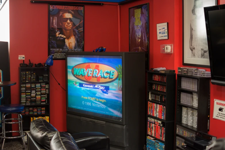 a living room with a red wall and entertainment center