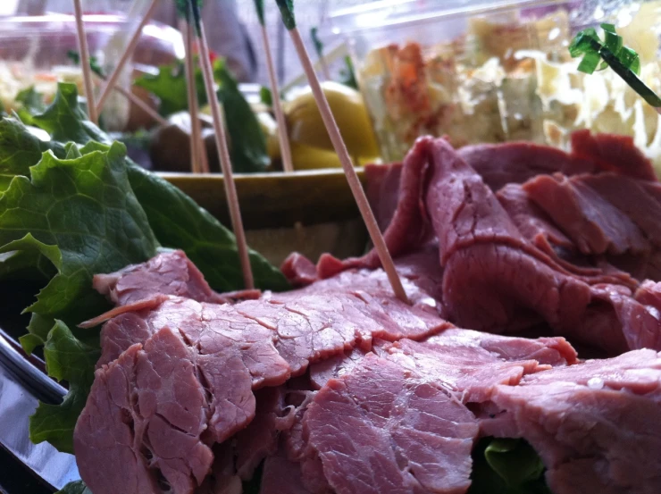 a closeup of sliced meat on display at a buffet