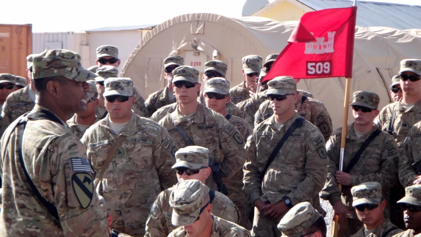 military men in uniforms standing with flags and signs