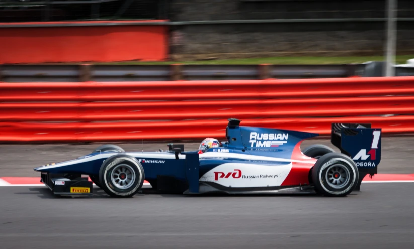 man racing a formula car on a track