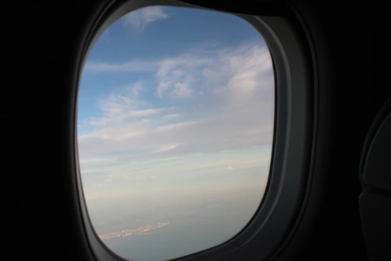 a view from a plane window shows the clouds