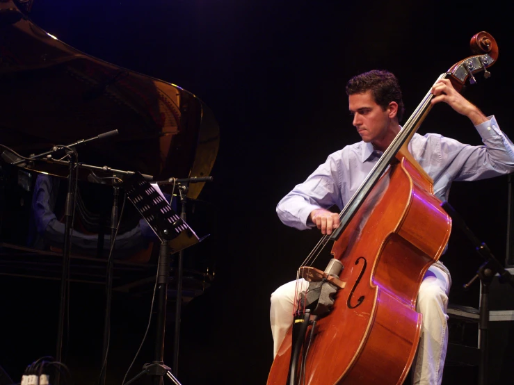 a person on a stage holding onto an instrument