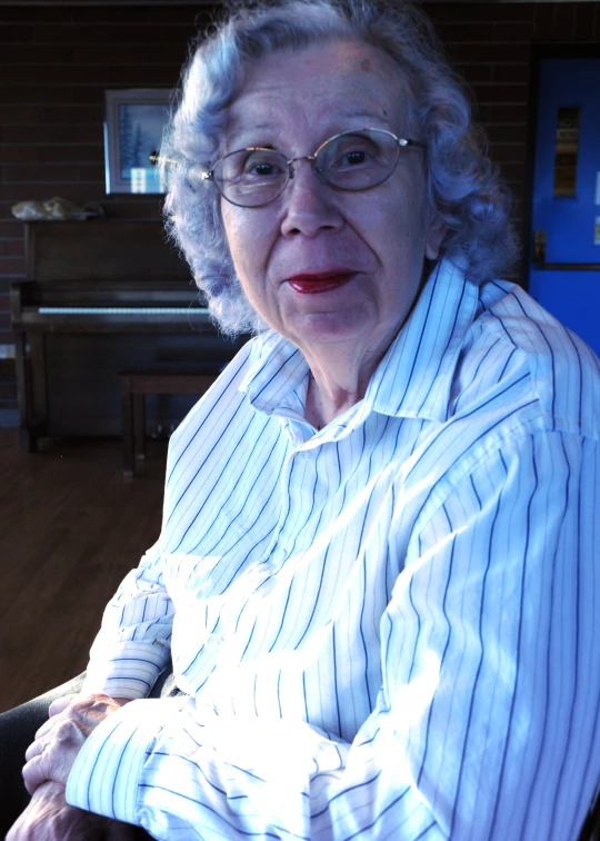 an elderly woman is staring into the camera