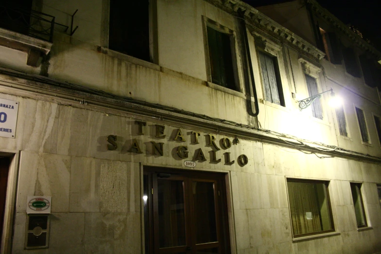 a restaurant at night with the door ajar