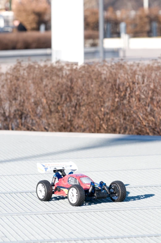 a toy car is sitting on the cement surface